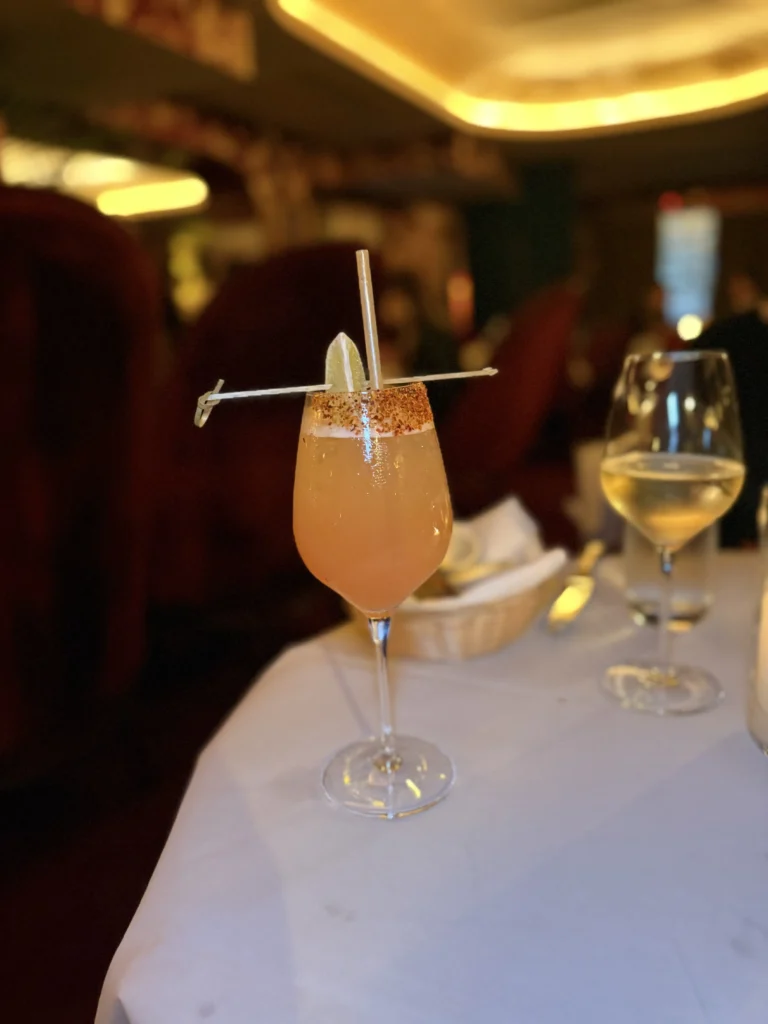 Phoenix mezcal cocktail with chili rim and lime garnish