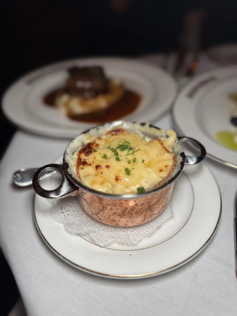 Gruyere mac and cheese in copper pot with golden broiled crust