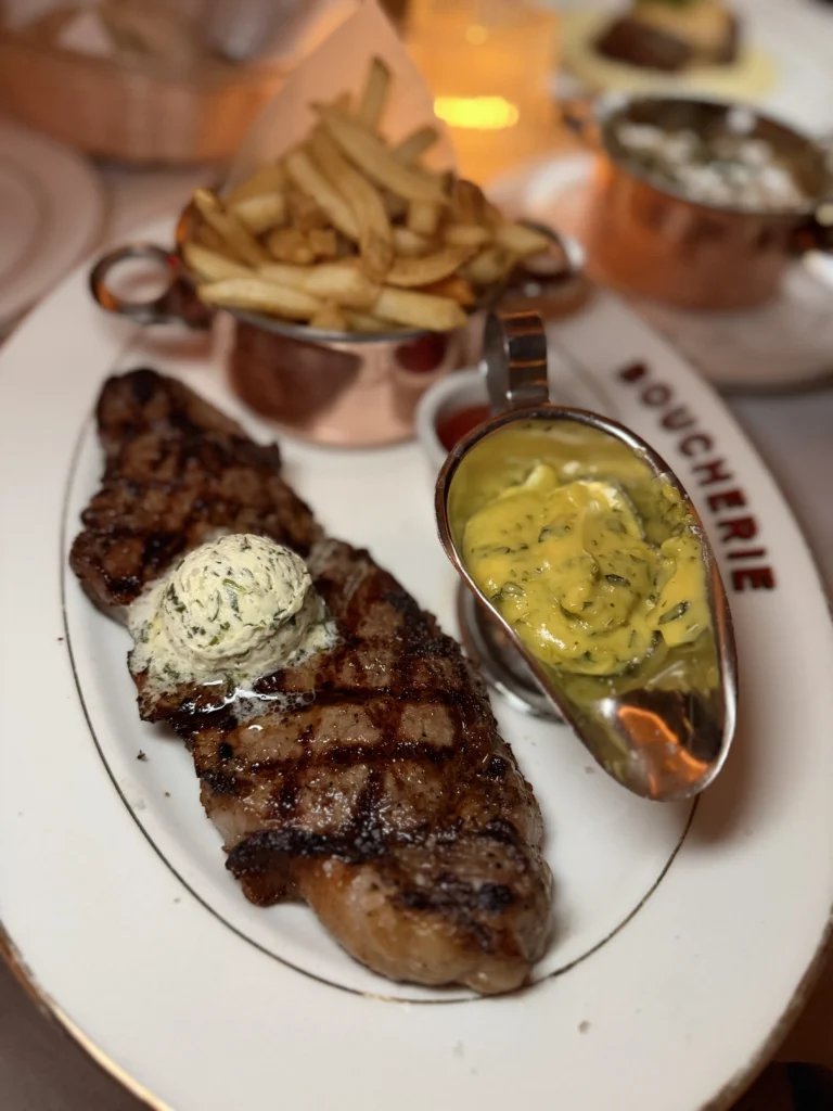 Prime NY strip steak frites with herb butter and bearnaise sauce