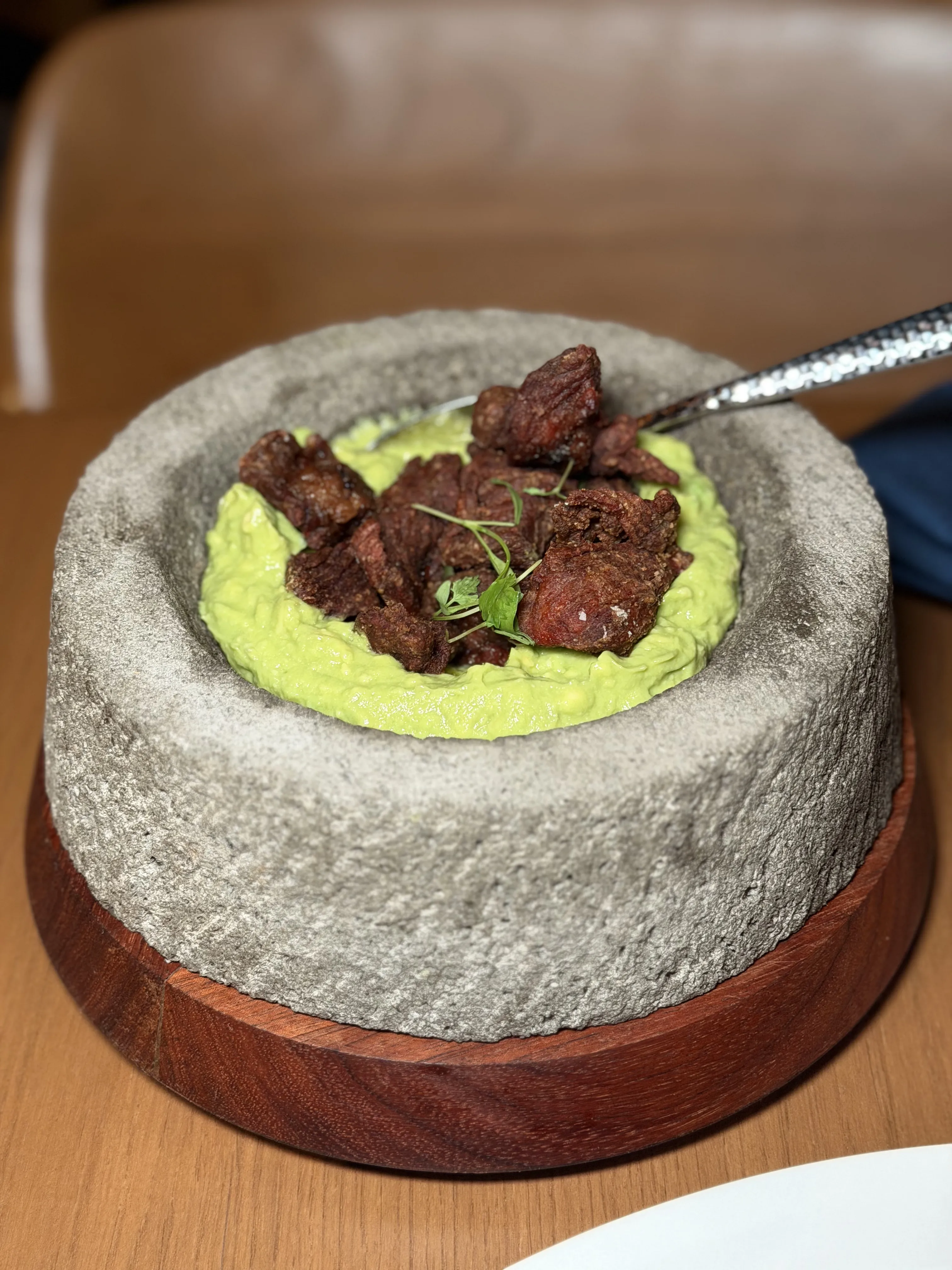 Chicharrón de ribeye in molcajete with avocado purée