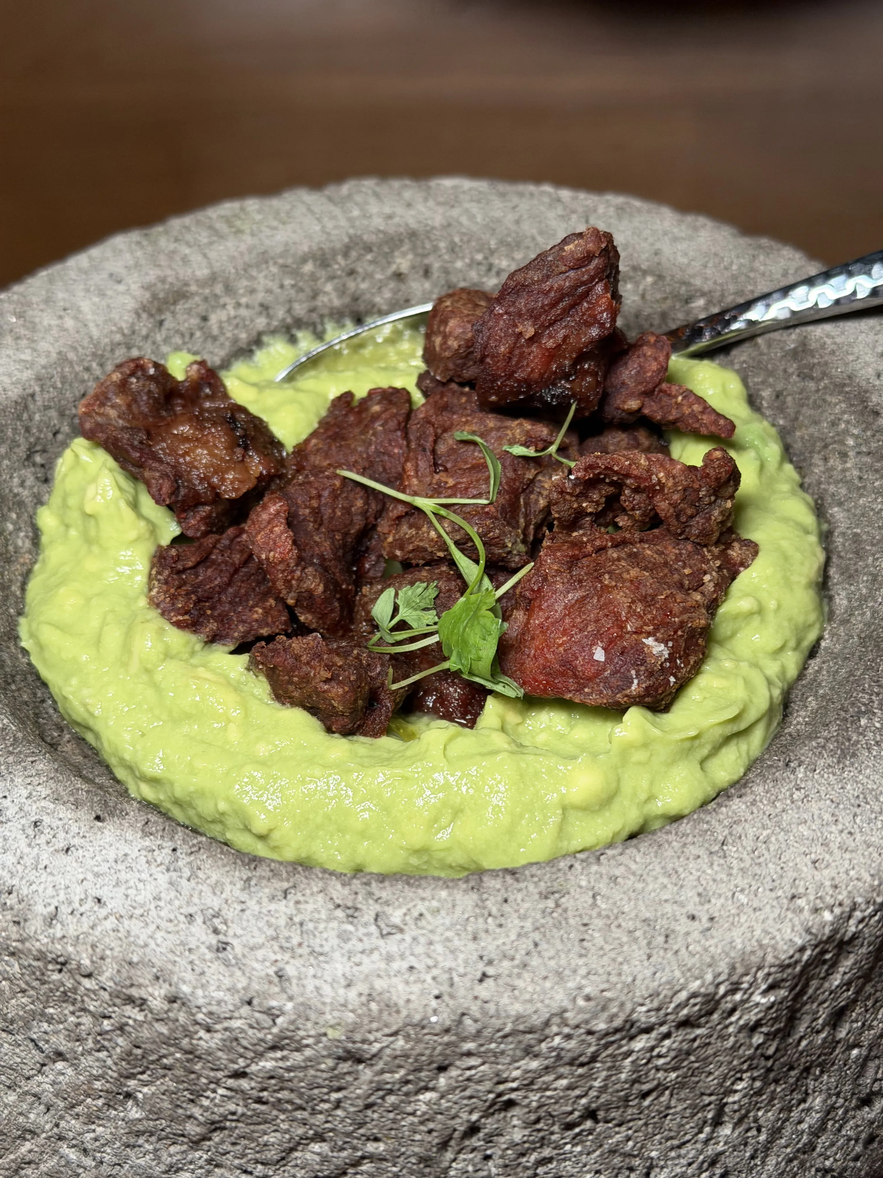 Close-up of crispy Wagyu ribeye chicharrón with avocado purée