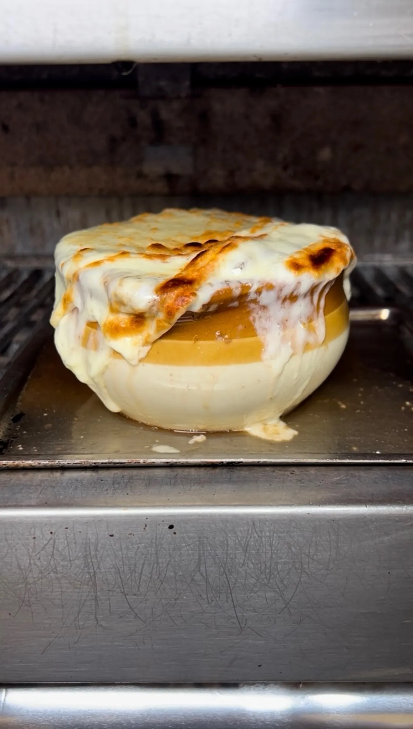 French onion soup fresh from the oven with broiled melted Gruyere