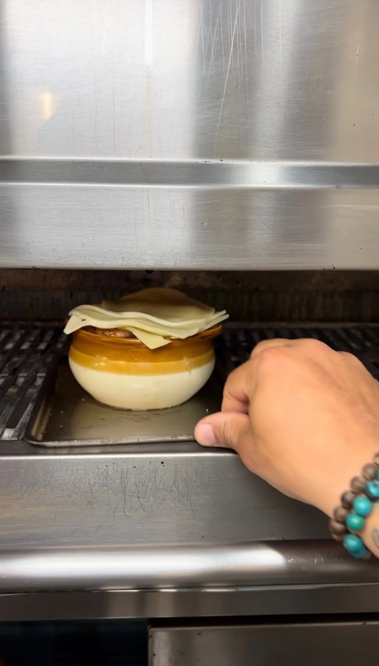 French onion soup bowls under the oven broiler with cheese melting