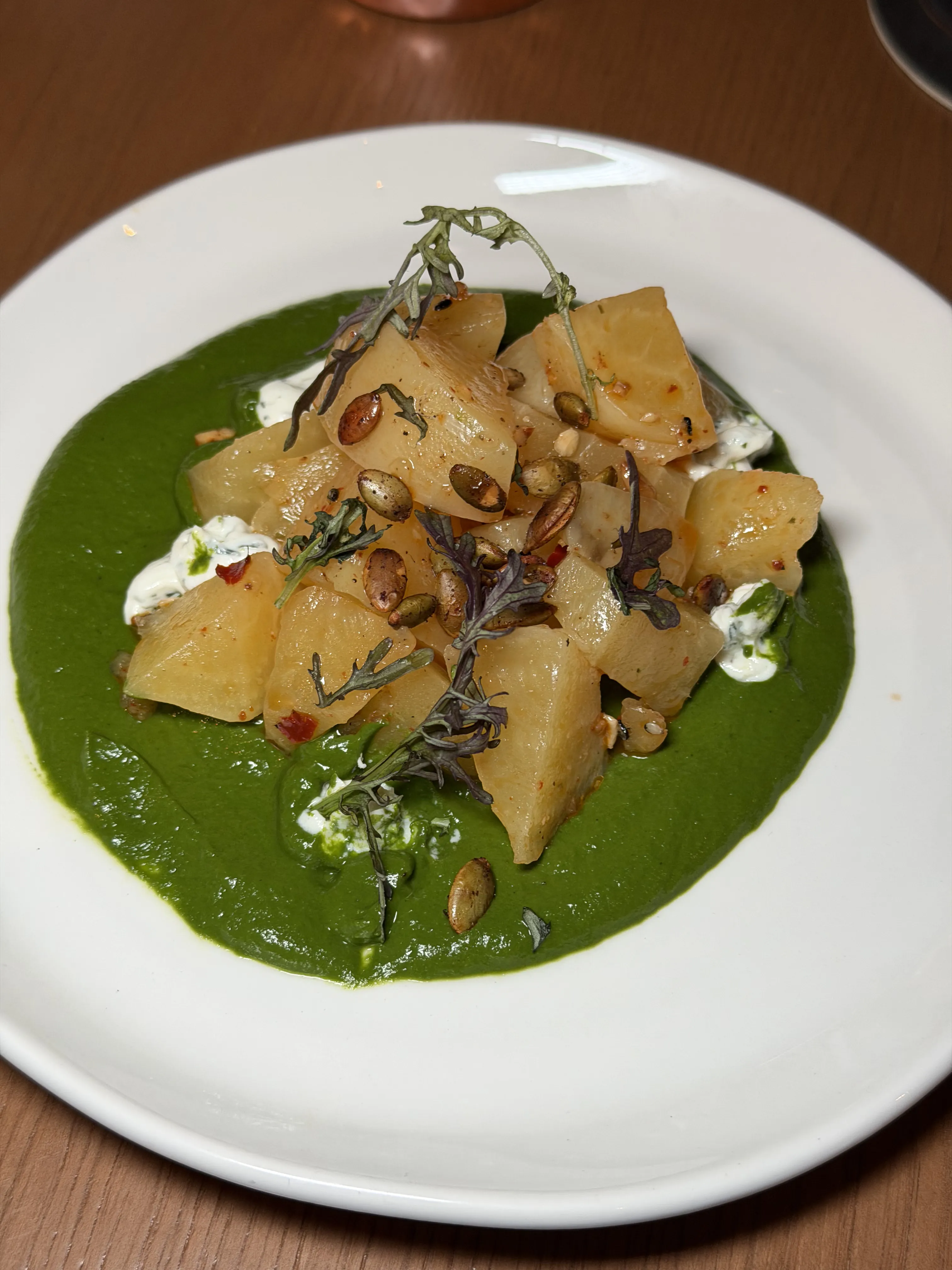 Golden beets with green sauce, goat cheese, and microgreens