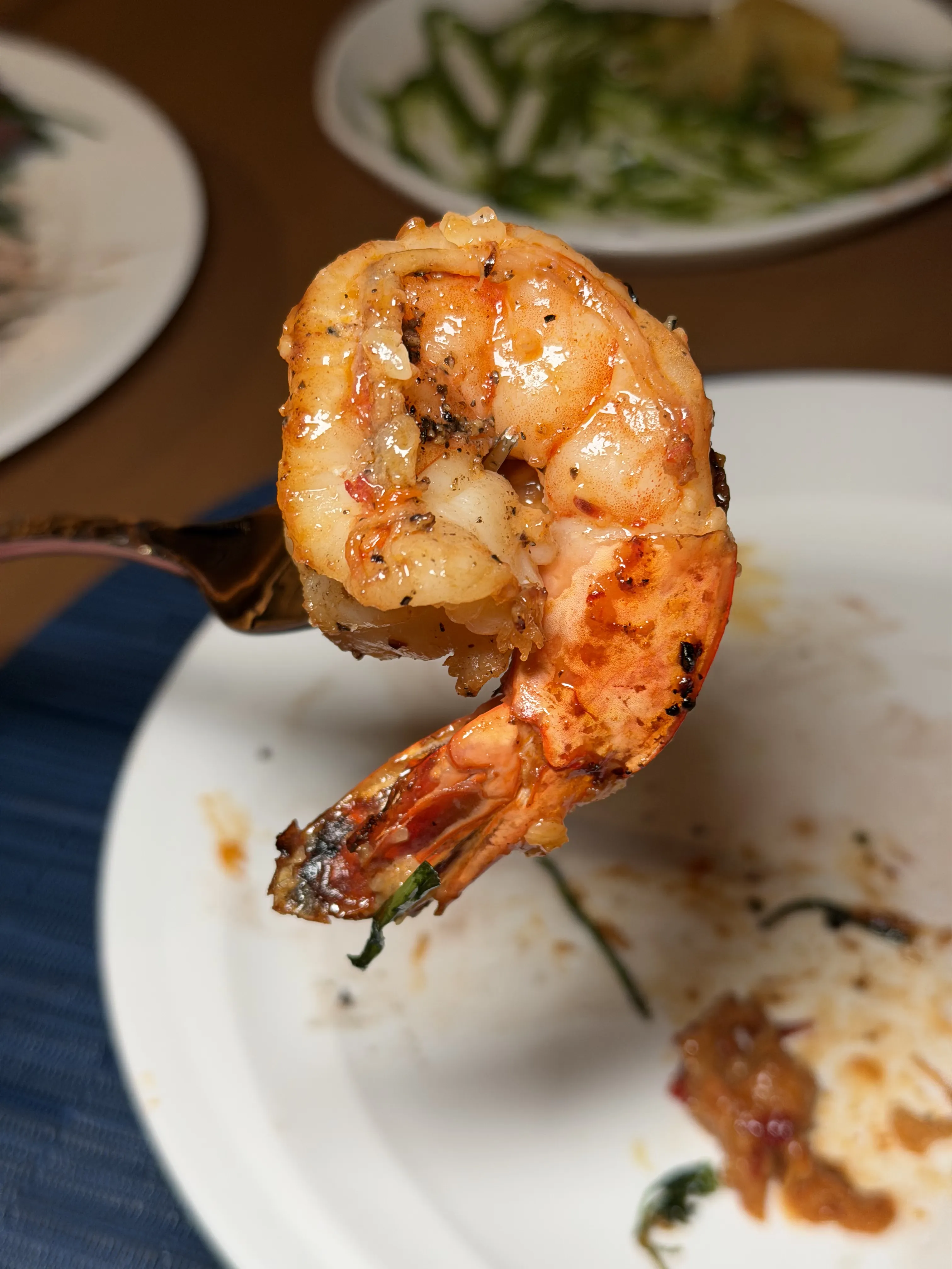 Grilled jumbo shrimp on fork at The Mexican restaurant