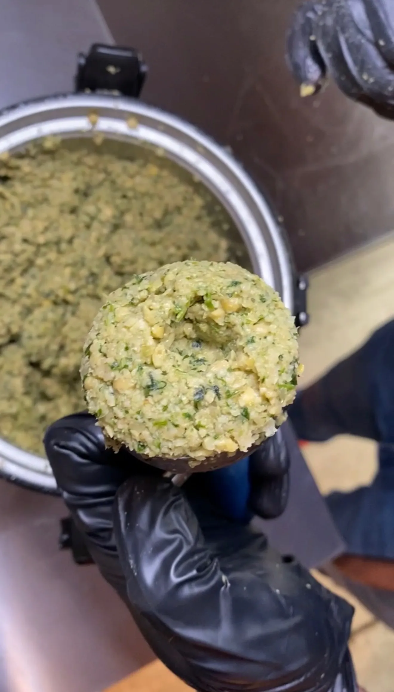 Homemade falafel ball being shaped by hand