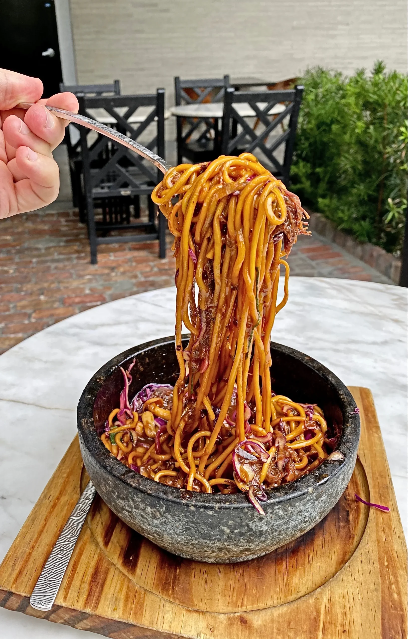 Korean noodles lifted from a hot stone bowl