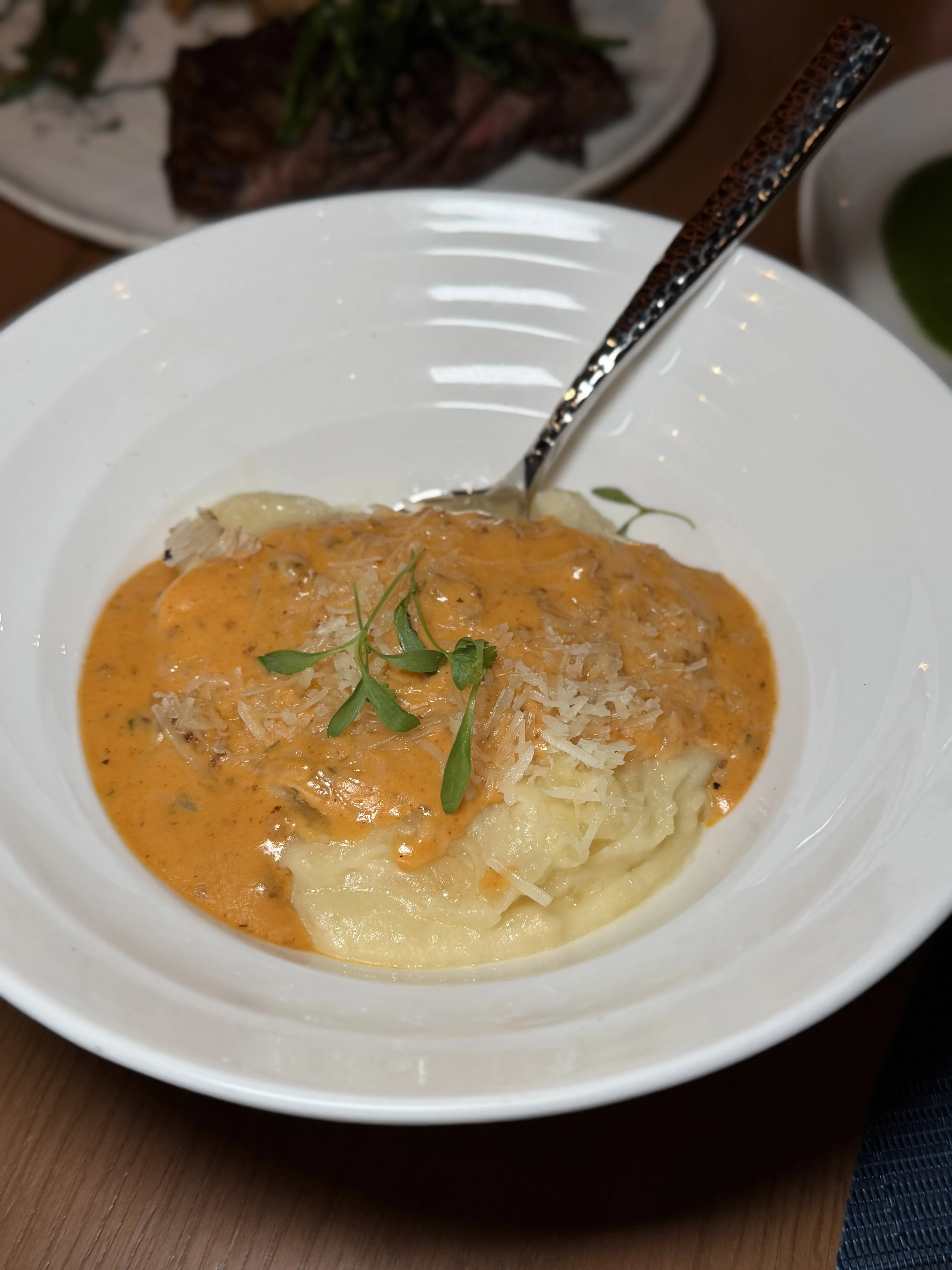 Manchego whipped potatoes with chorizo gravy on restaurant plate