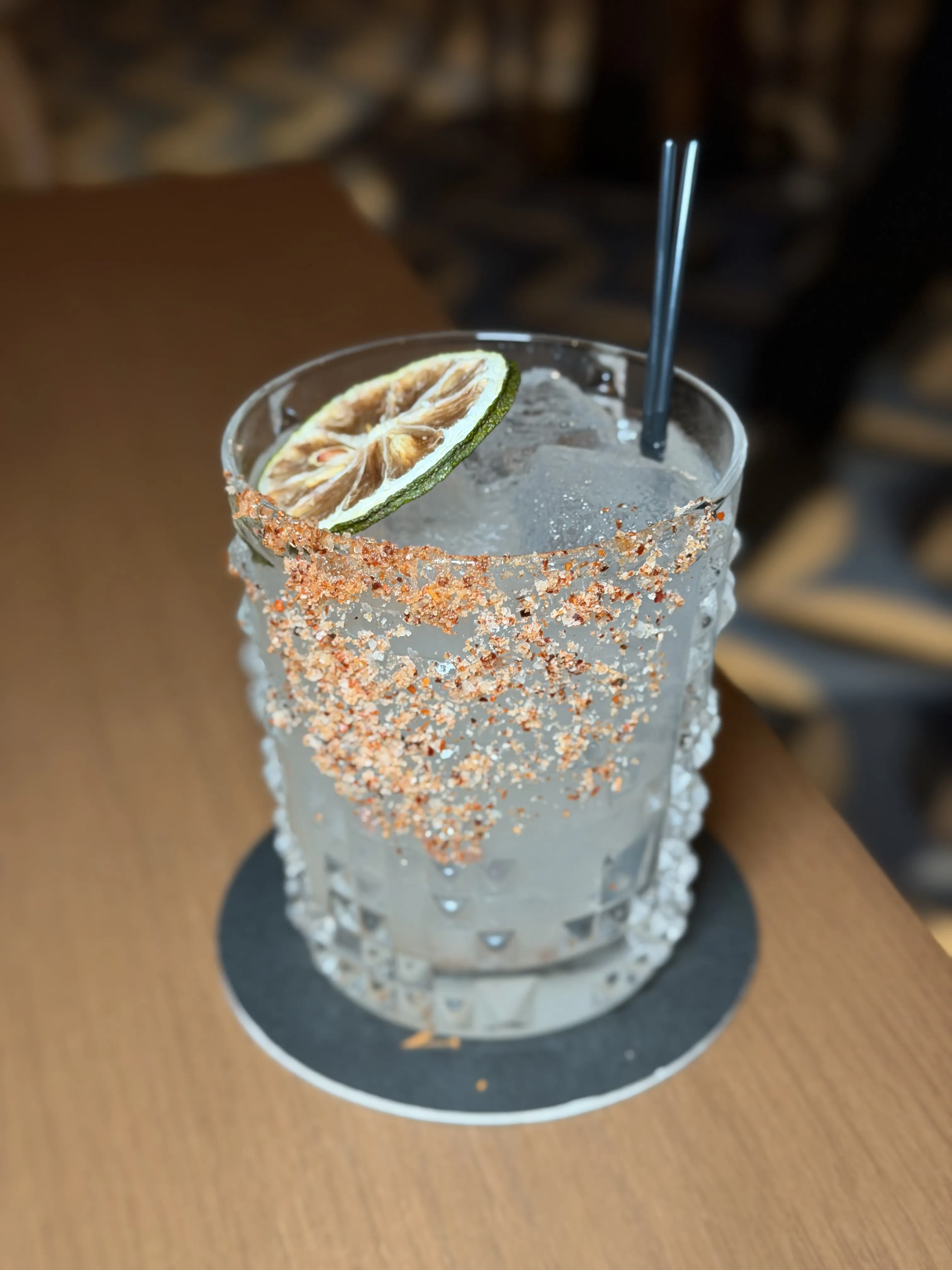 Mezcal cocktail with chili salt rim and lime garnish