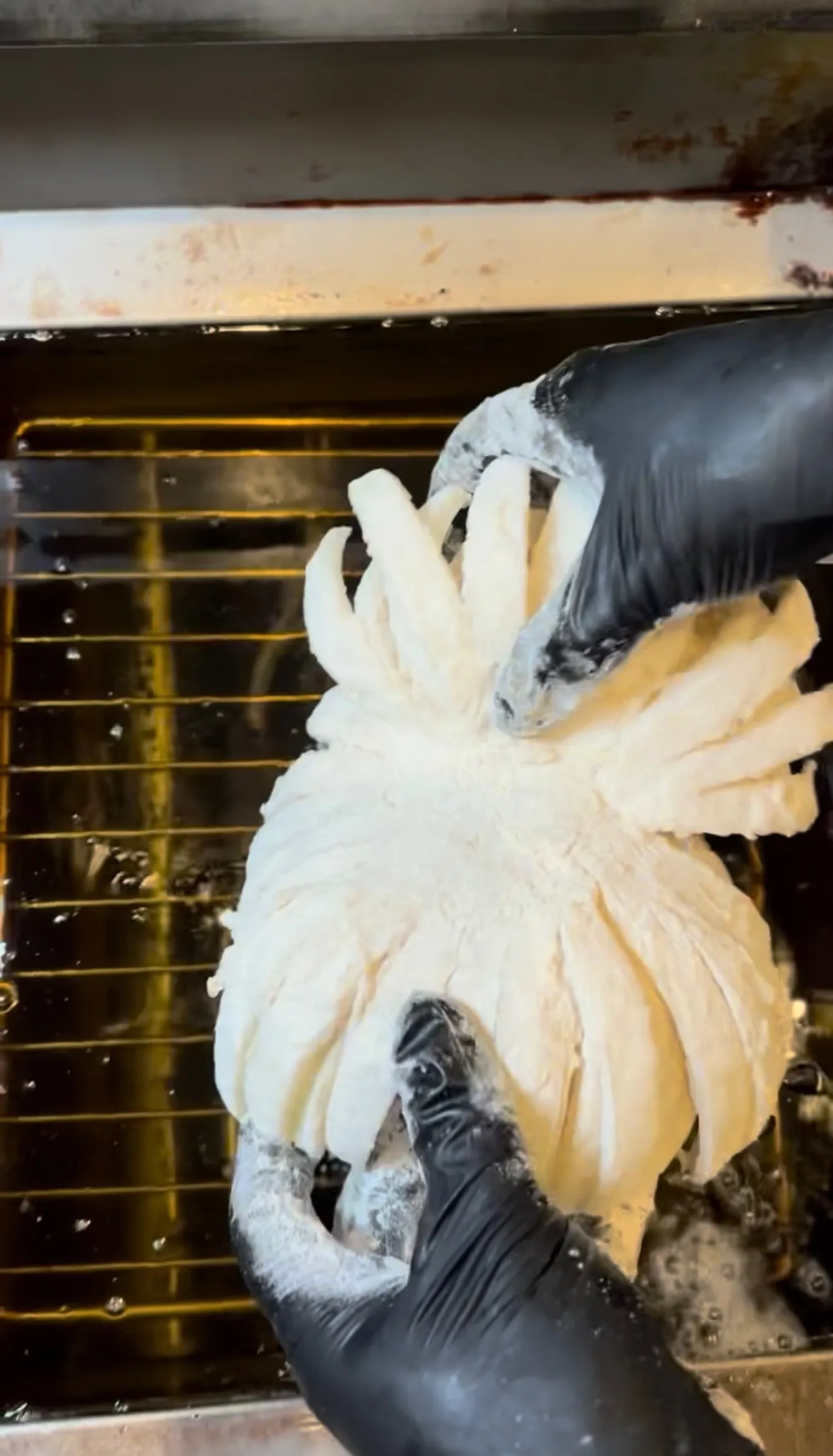 Raw blooming onion on an oven rack before frying
