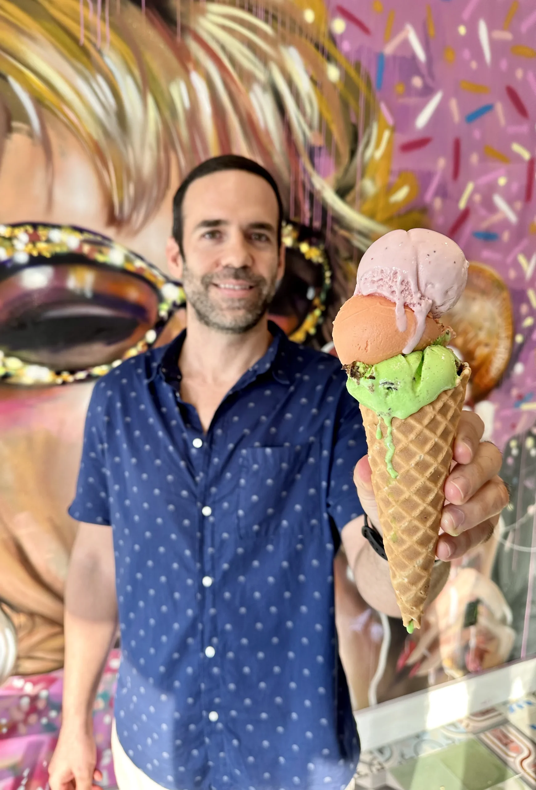 Yanni holding a triple-scoop ice cream cone