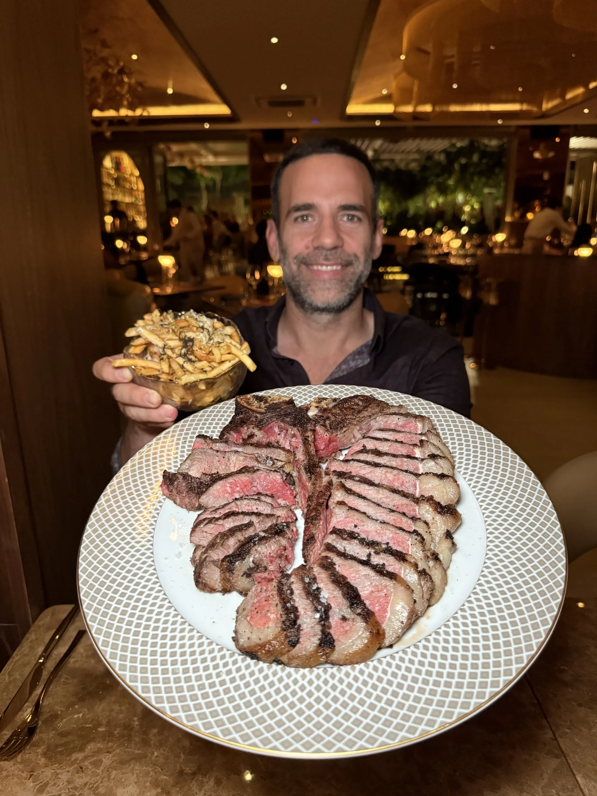 Yanni presenting a sliced steak platter